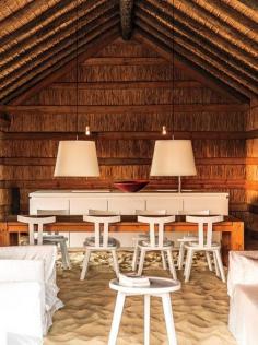 The living area at Casas Na Areia, a small hotel made up of traditional thatched huts designed by architect Manuel Aires Mateus and run by João Rodrigues (the property was chosen to represent Portugal at the Venice Architecture Biennale in 2010).