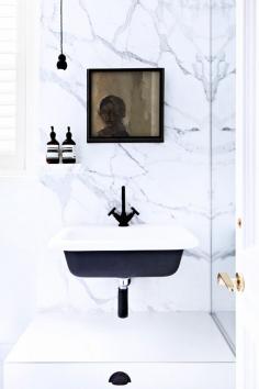 
                    
                        Black and white bathroom with marble walls
                    
                