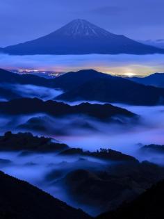 
                    
                        Mt Fuji, Japan. Before dawn. The beautiful harmony of night view appeared. The cloud was colored beautifully by the lights under the sea of clouds.
                    
                