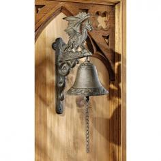 Gothic dragon iron bell Solid cast iron Hand-applied verdigris finish Dimensions: 4W x 4D x 9.5H inches. Due to a recent influx of books, movies and television shows, the myth and mystique of dragons - and fantasy stories and medieval times in general - has never been more popular than right now. Fans of the genre can enjoy greeting their guests with this Design Toscano Dragon of Murdock Manor Gothic Iron Bell. Constructed from solid cast iron and hand finished, this Design Toscano exclusive makes a distinctive echo when you or guests enter your home. The bell, which extends nearly five inches from the wall, is also a perfect gift for a loved one who enjoys living life in the fantasy realm. About Design Toscano: Design Toscano is the country's premier source for statues and other historical and antique replicas, which are available through the company's catalog and website. Design Toscano's founders, Michael and Marilyn Stopka, created Design Toscano in 1990. While on a trip to Paris, the Stopkas first saw the marvelous carvings of gargoyles and water spouts at the Notre Dame Cathedral. Inspired by the beauty and mystery of these pieces, they decided to introduce the world of medieval gargoyles to America in 1993. On a later trip to Albi, France, the Stopkas had the pleasure of being exposed to the world of Jacquard tapestries that they added quickly to the growing catalog. Since then, the company's product line has grown to include Egyptian, Medieval and other period pieces that are now among the current favorites of Design Toscano customers, along with an extensive collection of garden fountains, statuary, authentic canvas replicas of oil painting masterpieces, and other antique art reproductions. At Design Toscano, attention to detail is important. Travel directly to the source for all historical replicas ensures brilliant design.
